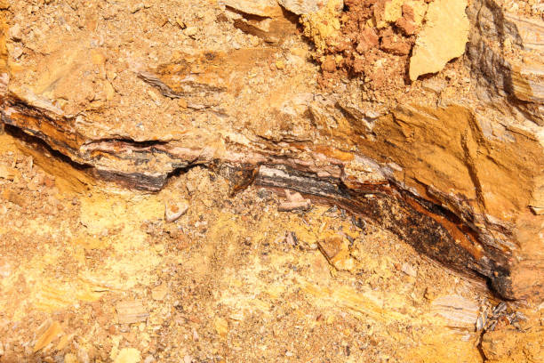 Cobalt ore visible in a freshly excavated pit at a mining site in the Democratic Republic of Congo.