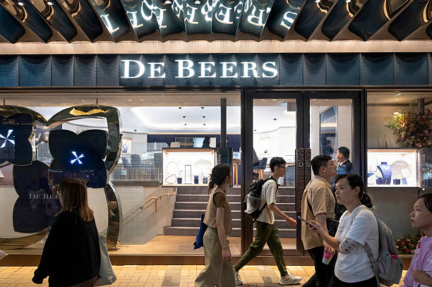 People walk past a De Beers jewellery store in Hong Kong.