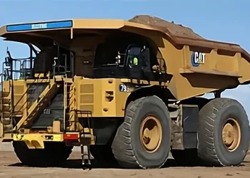 A battery-electric haul truck in operation at BHP’s Jimblebar iron ore mine in Western Australia. Mining companies are increasingly investing in electric vehicles and renewable energy to meet climate targets and reduce emissions from heavy industrial operations.