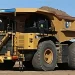 A battery-electric haul truck in operation at BHP’s Jimblebar iron ore mine in Western Australia. Mining companies are increasingly investing in electric vehicles and renewable energy to meet climate targets and reduce emissions from heavy industrial operations.