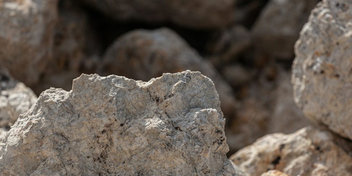 A piece of spodumene, a lithium-bearing ore, is seen in this file photo as Zimbabwe increases lithium exports but faces pressure from weak global prices.