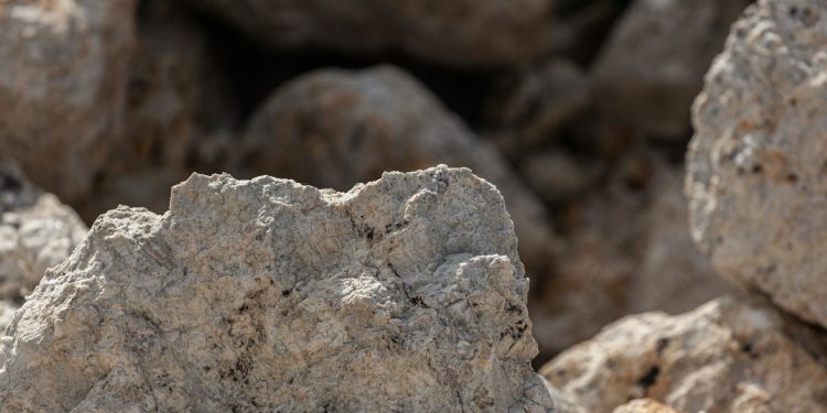 A piece of spodumene, a lithium-bearing ore, is seen in this file photo as Zimbabwe increases lithium exports but faces pressure from weak global prices.