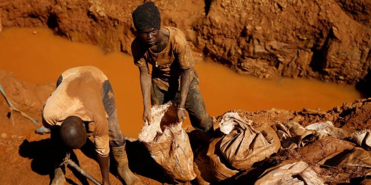 Artisanal gold miners work at a shallow open-pit mine in rural Zimbabwe.