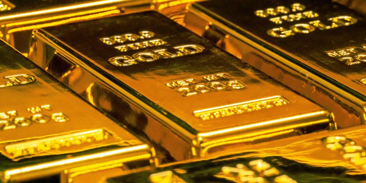 Gold bars stacked together with purity markings visible.