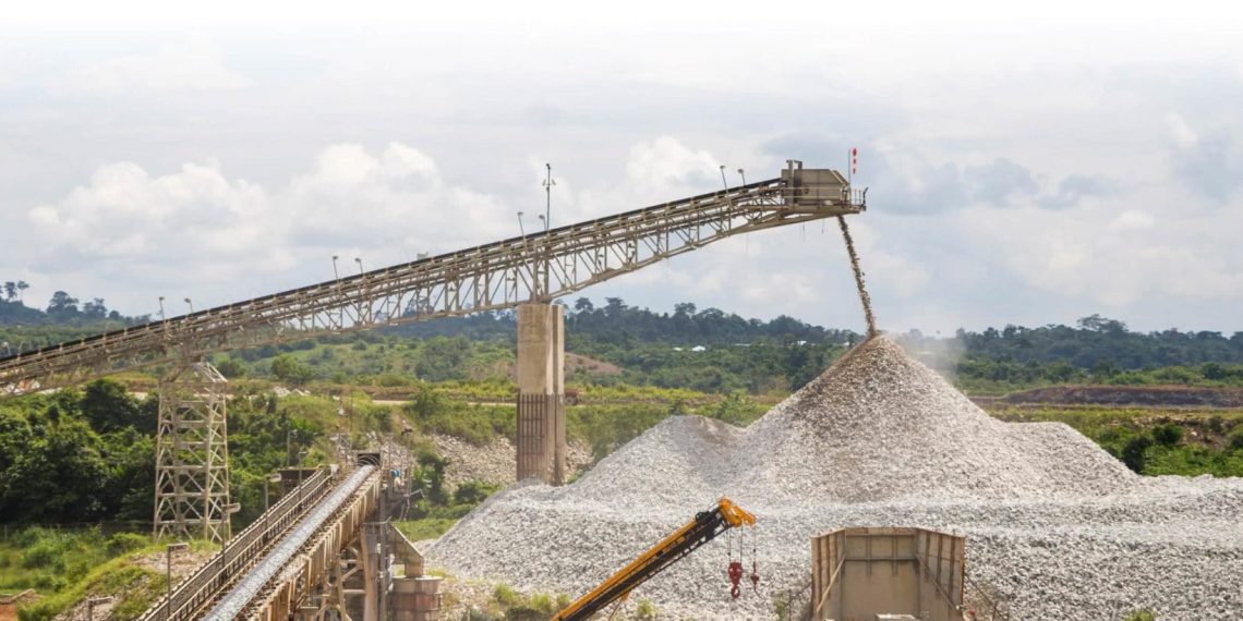 Mining conveyor belt depositing crushed stone at a Sudanese site.