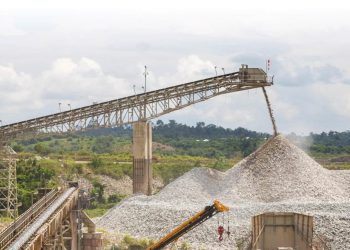 Mining conveyor belt depositing crushed stone at a Sudanese site.