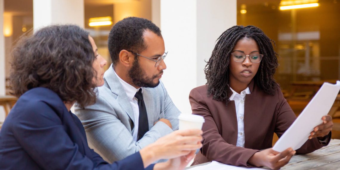 Legal expert explaining contract details to a client in an office