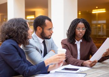 Legal expert explaining contract details to a client in an office