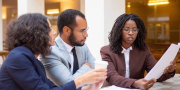 Legal expert explaining contract details to a client in an office