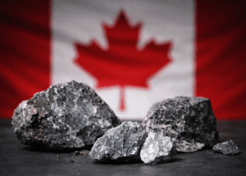Rare earth mineral ore samples in front of a Canadian flag