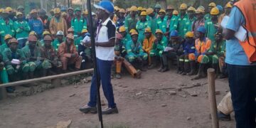 Mine workers in Zimbabwe listen to union officials during a gathering.