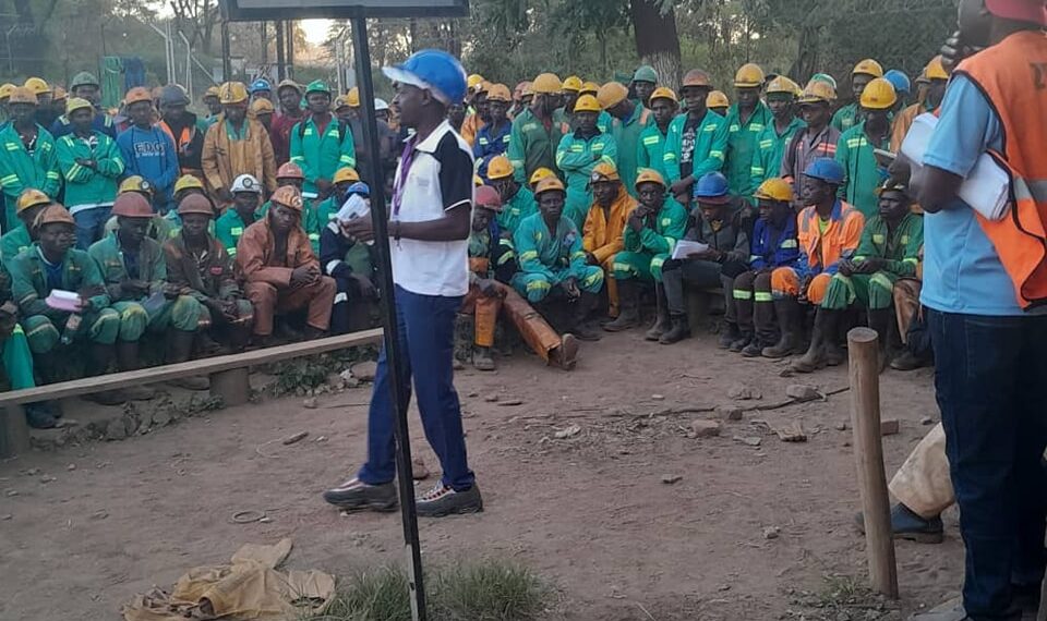 Mine workers in Zimbabwe listen to union officials during a gathering.