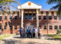 Zimbabwe School of Mines building in Bulawayo with people gathered outside.