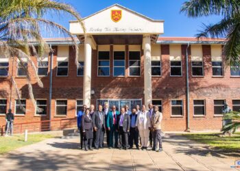 Zimbabwe School of Mines building in Bulawayo with people gathered outside.