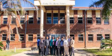 Zimbabwe School of Mines building in Bulawayo with people gathered outside.