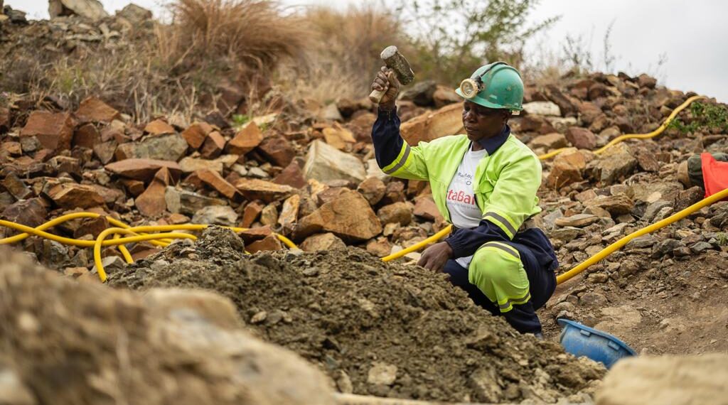 A woman miner works at an artisanal and small-scale mining site.