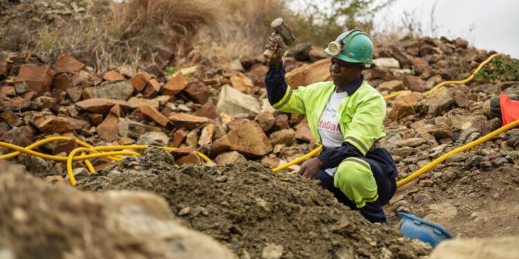 A woman miner works at an artisanal and small-scale mining site.