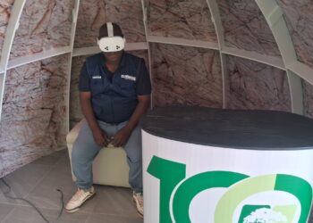 ZiMining editor Thomas Chidamba wears a VR headset inside a geodesic dome display at the Mimosa Mine stand, Zimbabwe Agricultural Show, August 26, 2026.