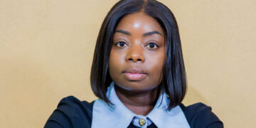 Eng. Gloria Gawe Bususu poses for a professional portrait with arms crossed.
