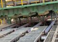 Freshly cast square steel billets move along rollers inside Dinson Iron and Steel Company's steel plant in Manhize, Zimbabwe.