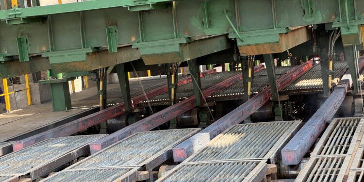 Freshly cast square steel billets move along rollers inside Dinson Iron and Steel Company's steel plant in Manhize, Zimbabwe.