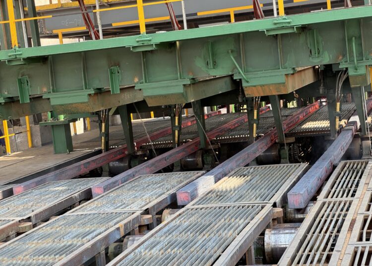Freshly cast square steel billets move along rollers inside Dinson Iron and Steel Company's steel plant in Manhize, Zimbabwe.