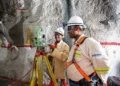 Mine surveyors using a total station to survey underground mine workings