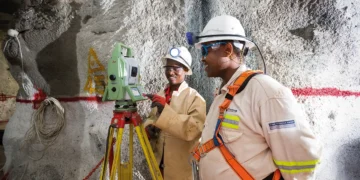 Mine surveyors using a total station to survey underground mine workings