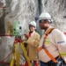 Mine surveyors using a total station to survey underground mine workings