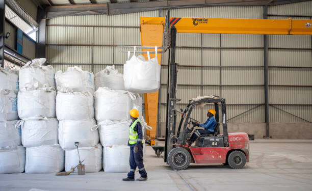 Forklift moves bulk bags of spodumene concentrate inside Bikita Minerals warehouse.