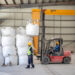 Forklift moves bulk bags of spodumene concentrate inside Bikita Minerals warehouse.