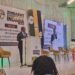 Minister Polite Kambamura speaks at a podium during the Zimbabwe Alternative Mining Indaba, with banners showing the event theme on sustainable development.