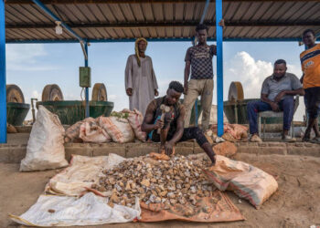 Workers process gold-bearing ore at a small-scale mining operation near Atbara, Sudan, in a file photograph.