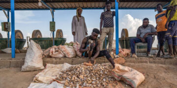 Workers process gold-bearing ore at a small-scale mining operation near Atbara, Sudan, in a file photograph.