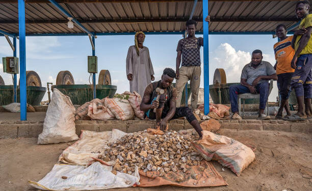 Workers process gold-bearing ore at a small-scale mining operation near Atbara, Sudan, in a file photograph.