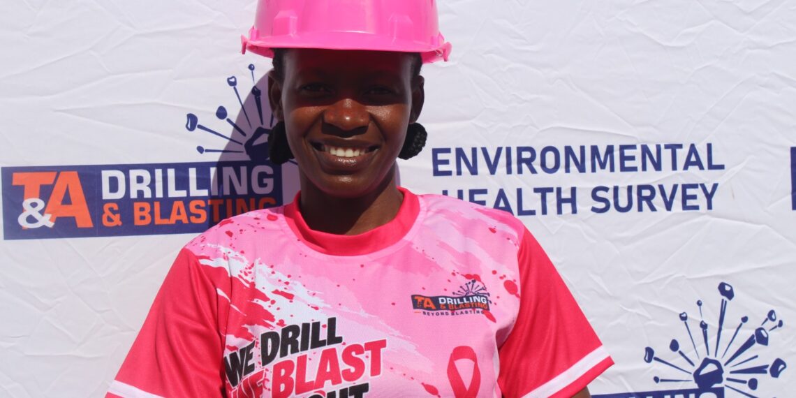 A T&A Drilling and Blasting staff member in a pink hard hat and company shirt at the breast cancer awareness campaign in Hatcliff