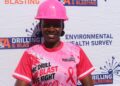 A T&A Drilling and Blasting staff member in a pink hard hat and company shirt at the breast cancer awareness campaign in Hatcliff