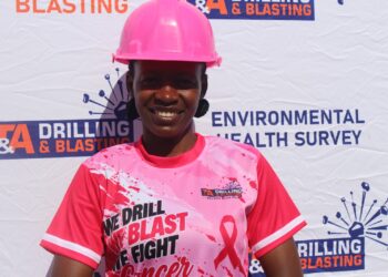 A T&A Drilling and Blasting staff member in a pink hard hat and company shirt at the breast cancer awareness campaign in Hatcliff