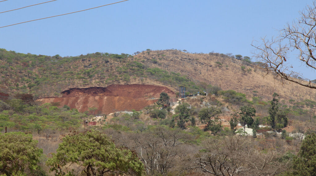 Christmas Pass Mountain near Mutare with a visibly disturbed section of hillside and exposed earth.