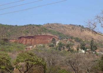 Christmas Pass Mountain near Mutare with a visibly disturbed section of hillside and exposed earth.