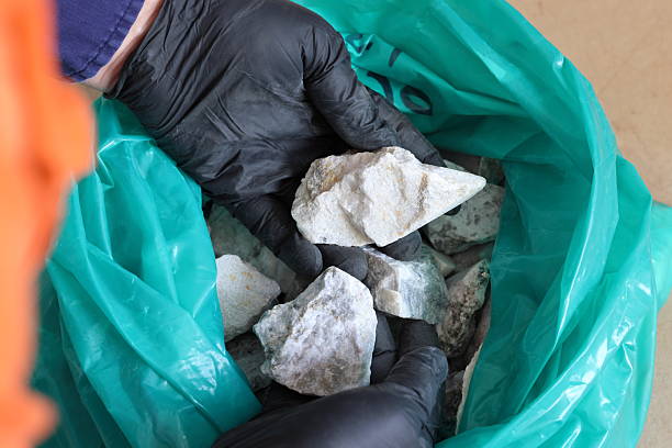 A sample of spodumene ore, a lithium-bearing mineral used to produce lithium concentrate, is examined by a geologist. Zimbabwe is seeking to increase local processing of its lithium resources. (Image: Pixabay)